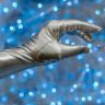 Close-up of a metallic glove against a vibrant blue bokeh background, evoking a futuristic theme.