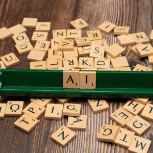 Scrabble tiles spelling 'AI' on a wooden surface symbolize artificial intelligence technology.