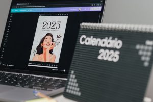 Organized office desk with 2025 calendar and laptop for modern productivity.