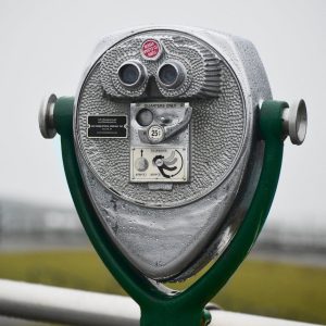 Close-up of a coin-operated viewer on a rainy day, perfect for observing scenic landscapes.