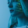 Tech-inspired portrait of a woman with digital code projected on her face, symbolizing cybersecurity.